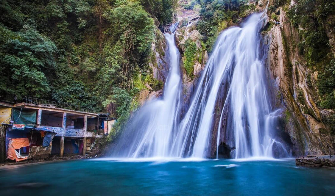 Kempty Falls in Mussoorie Uttarakhand with cascading waterfall, natural pool, and surrounding green hills popular among tourists